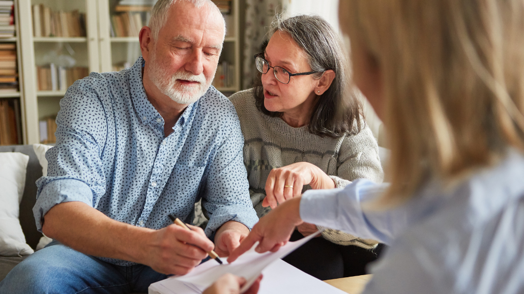 Senior couple signing power of attorney forms
