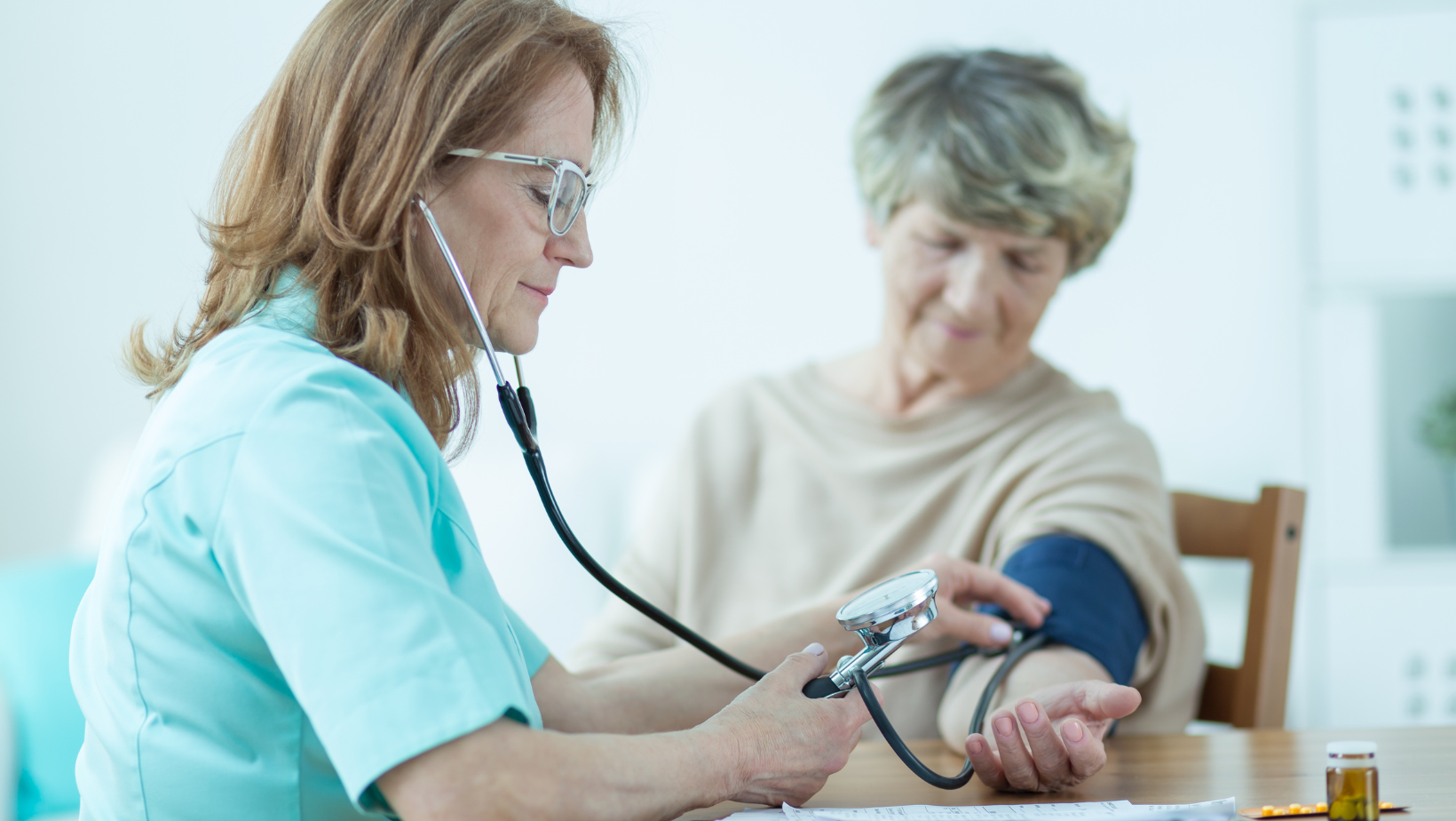 Nurse measuring a senior woman's blood pressure