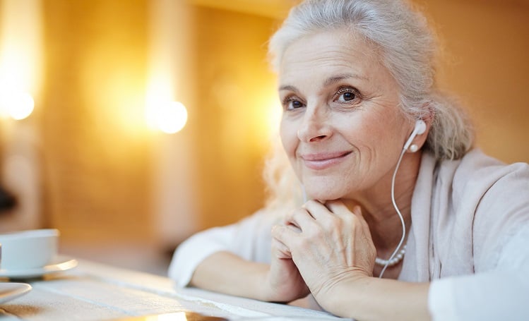 Senior woman smiling with headphones in