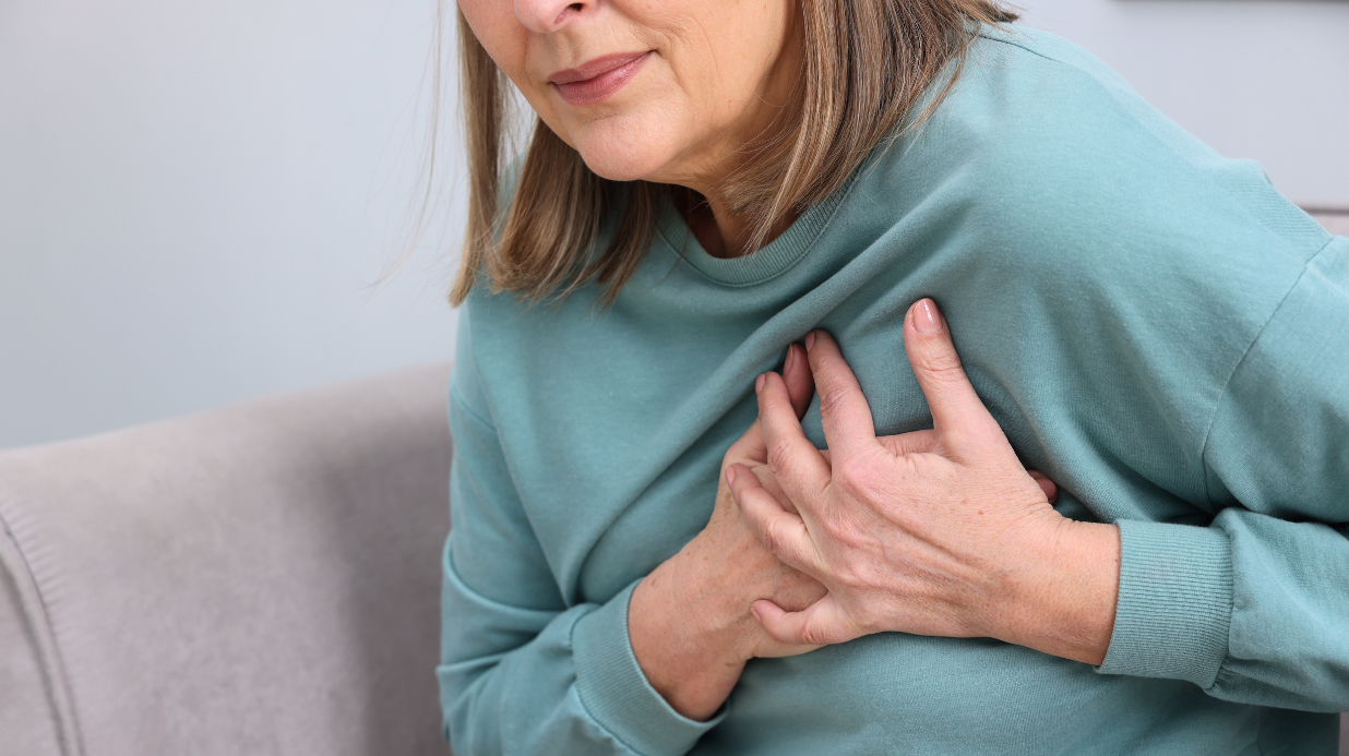 Elderly woman with heart failure who is clutching her chest