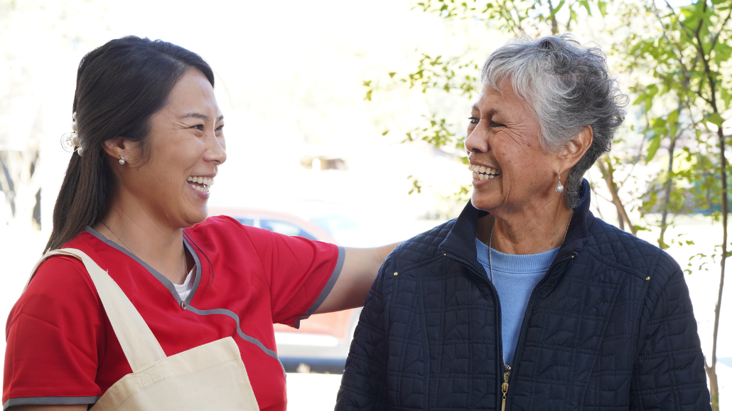 Caring Senior Service caregiver with a senior client outdoors