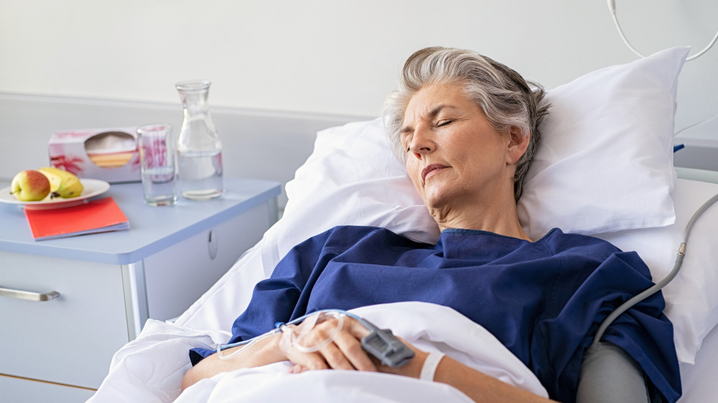 Senior woman sleeping in hospital bed
