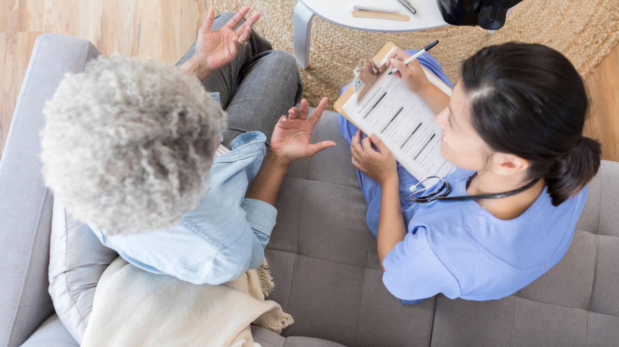 Overhead view of senior woman talking to a doctor