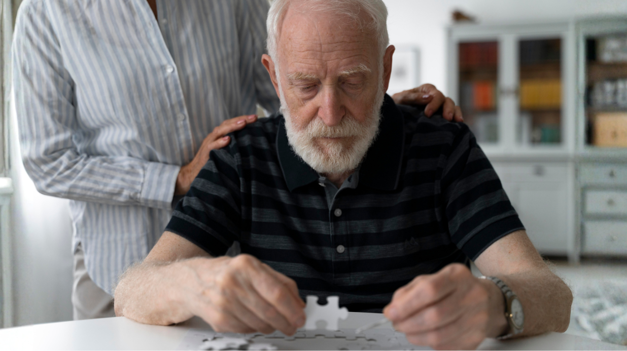 Senior man with dementia doing a puzzle