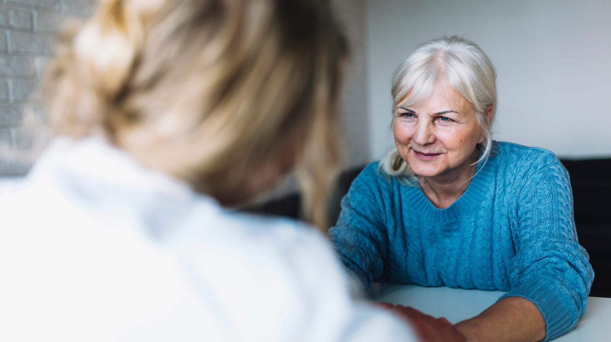 Senior woman listening to a caregiver