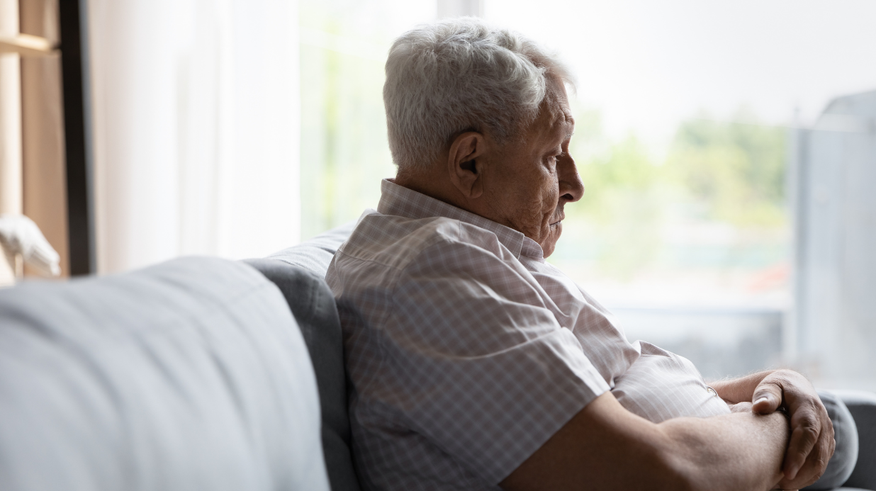 Elderly man with anxiety sitting on a couch
