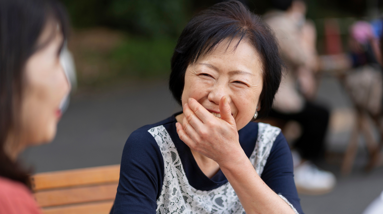 Blog Covers (37) Senior woman sitting outside on a bench with a friend while laughing