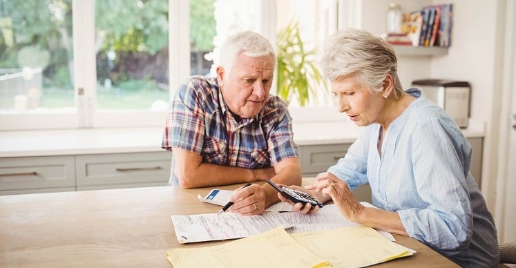 Senior couple reviewing financial documents together